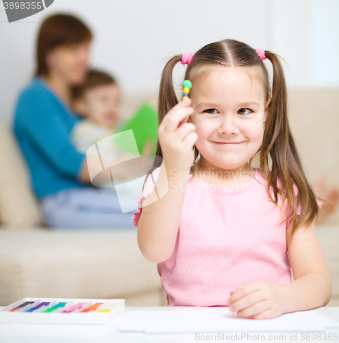 Image of Little girl is playing with plasticine