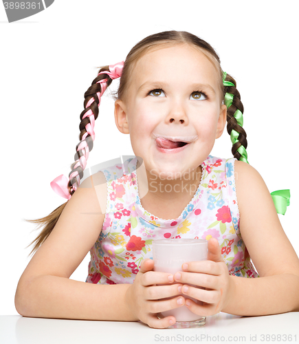 Image of Cute little girl with a glass of milk