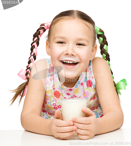 Image of Cute little girl showing milk moustache