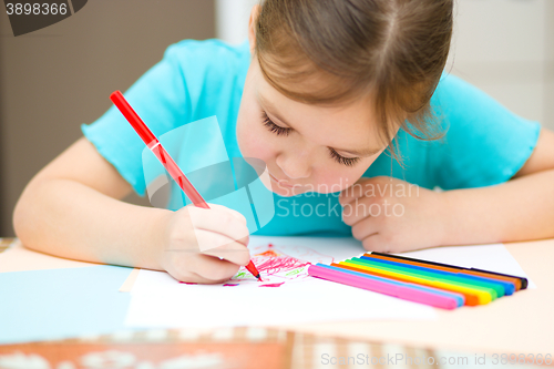 Image of Cute cheerful child drawing using felt-tip pen