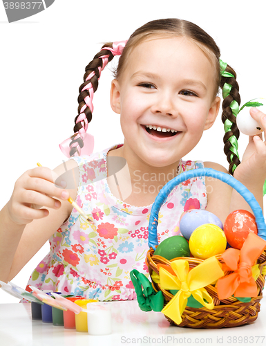 Image of Little girl preparing eggs for Easter