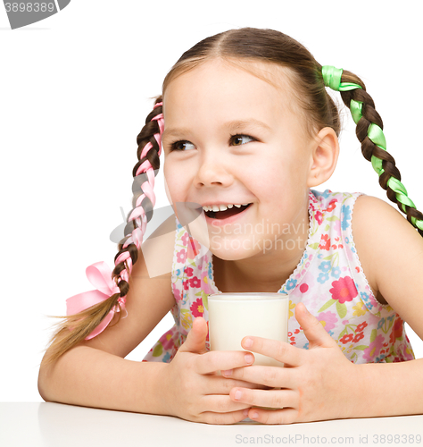 Image of Cute little girl with a glass of milk