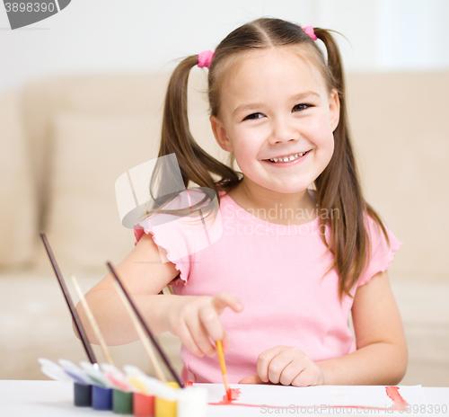 Image of Cute cheerful child play with paints