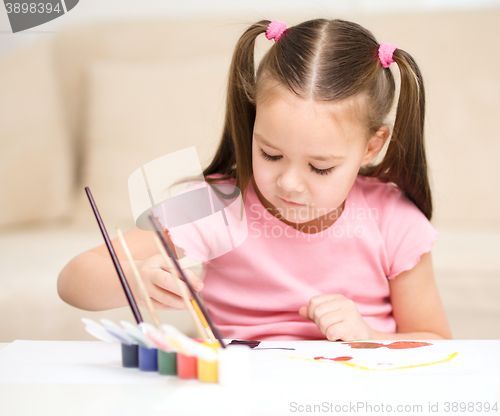 Image of Cute cheerful child play with paints