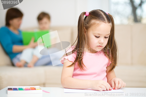 Image of Little girl is playing with plasticine