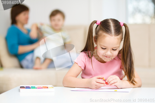 Image of Little girl is playing with plasticine