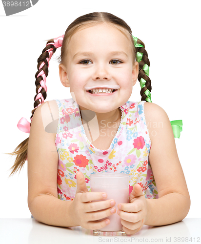 Image of Cute little girl showing milk moustache