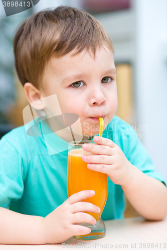 Image of Little boy with glass of orange juice