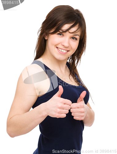 Image of Woman is showing thumb up gesture