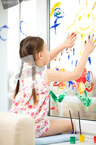 Image of Portrait of a cute girl playing with paints