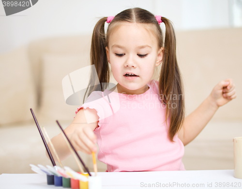 Image of Cute cheerful child play with paints