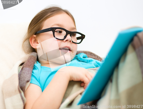 Image of Little girl is reading a book