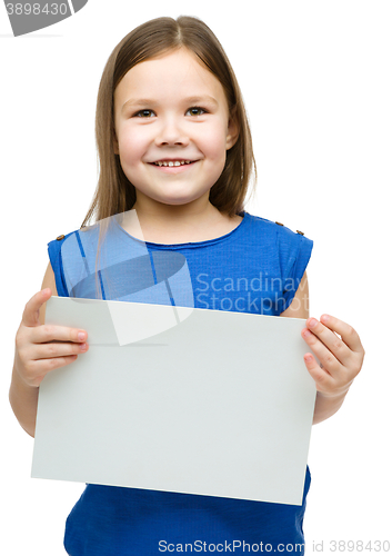 Image of Little girl is holding blank banner