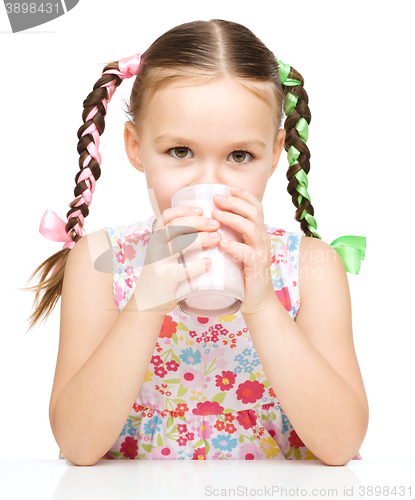 Image of Cute little girl with a glass of milk