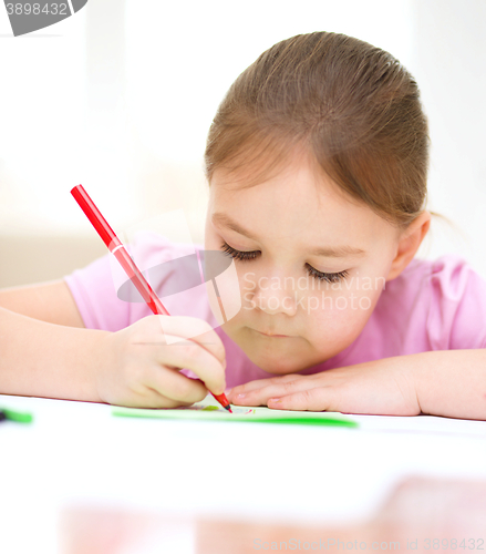 Image of Cute cheerful child drawing using felt-tip pen