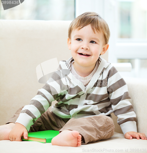 Image of Little boy is reading book