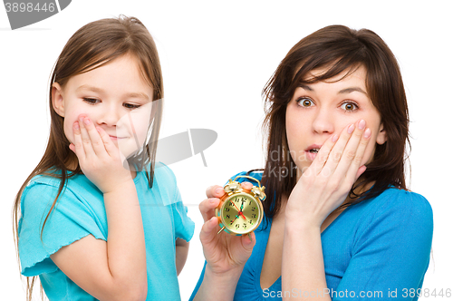 Image of Little girl and her mother are anxious about time