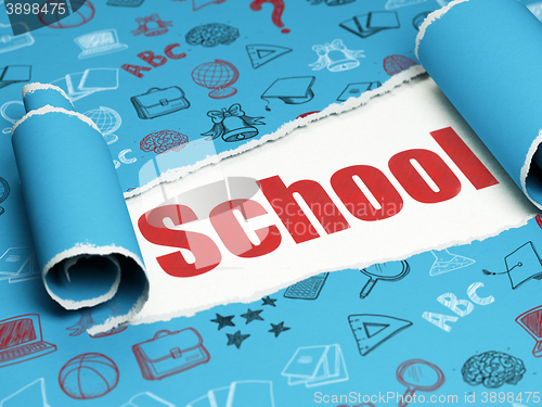 Image of Education concept: red text School under the piece of  torn paper