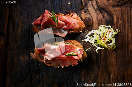 Image of Two slice of Spanish tapas with jamon