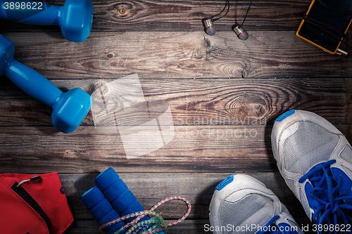 Image of Sport stuff on wooden table, top view