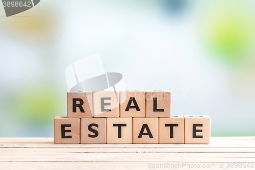 Image of Real estate sign on a wooden table