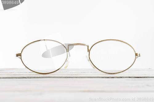 Image of Eyeglasses on a wooden desk