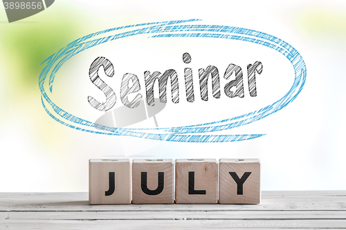 Image of July seminar message on a stage