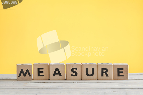 Image of Measure sign on a yellow background