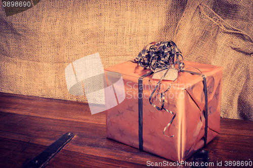 Image of Shiny Christmas present on a wooden desk