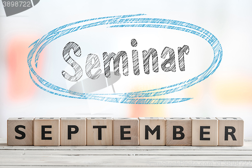 Image of September seminar sign with blue sketch