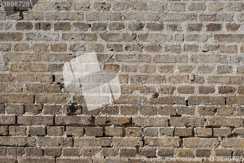 Image of Old brick wall with worn stones