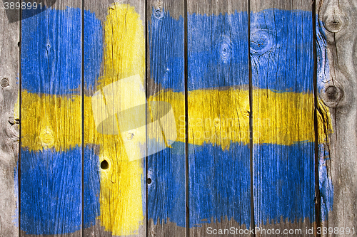 Image of swedish colors on old wooden wound