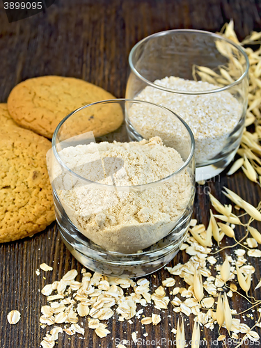 Image of Flour and bran oat in glass with cookies on board