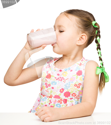 Image of Cute little girl with a glass of milk