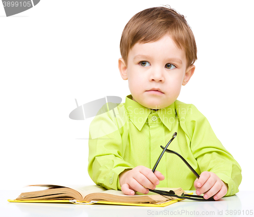 Image of Little child play with book