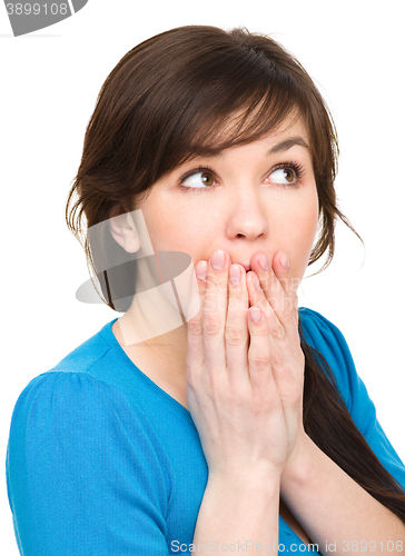 Image of Woman is covering her mouth in astonishment