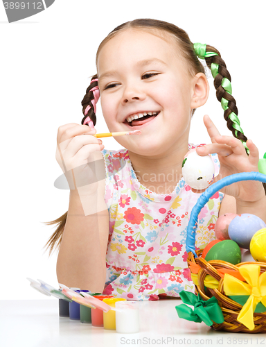 Image of Little girl preparing eggs for Easter