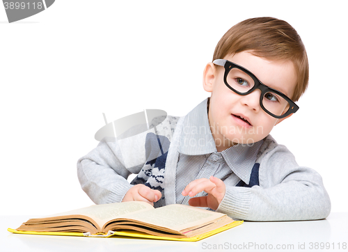 Image of Little child play with book