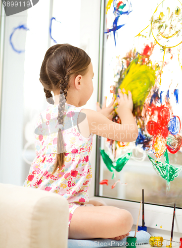 Image of Portrait of a cute girl playing with paints