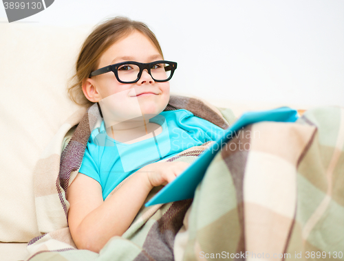 Image of Little girl is reading a book