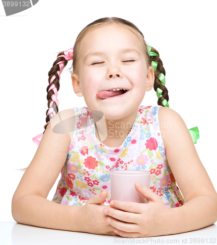 Image of Cute little girl with a glass of milk