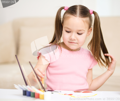 Image of Cute cheerful child play with paints