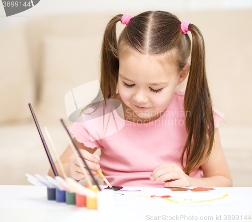 Image of Cute cheerful child play with paints