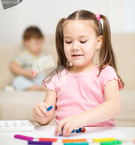 Image of Little girl is playing with plasticine