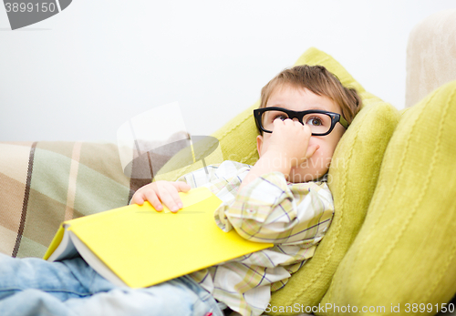 Image of Little boy is reading book