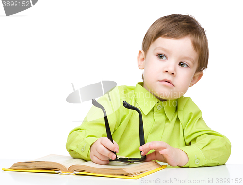 Image of Little child play with book