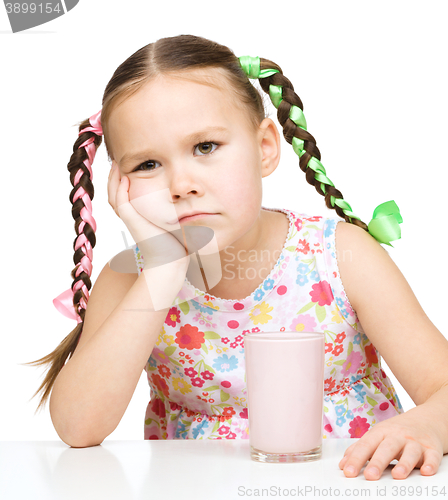 Image of Gloomy little girl doesn\'t want to drink milk