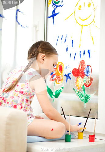 Image of Portrait of a cute girl playing with paints