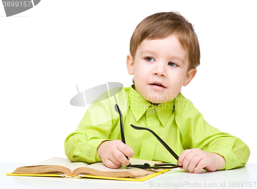 Image of Little child play with book