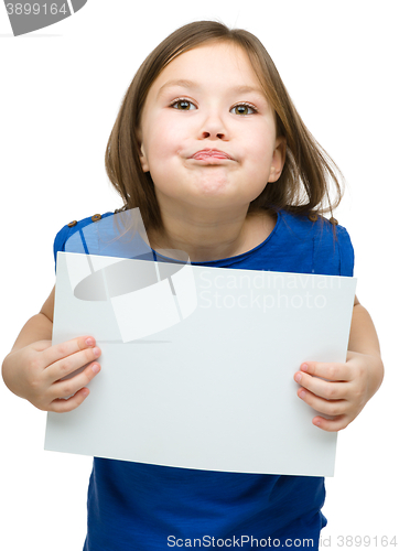 Image of Little girl is holding blank banner